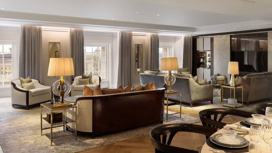 Large neutral living room with two seating vignettes flanked by lamps on side tables