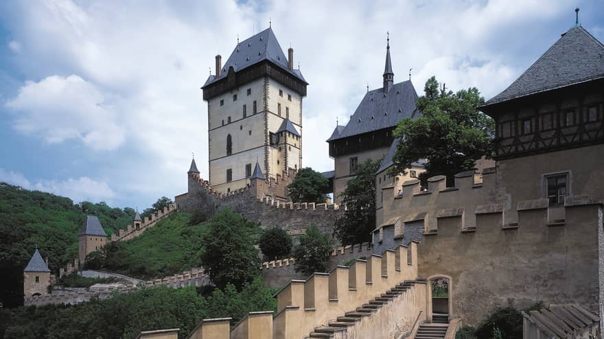 Looking up at historic Prague Karlstejn Castle towers, castle walls on sunny day