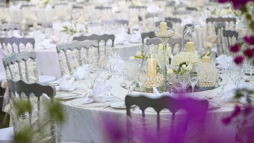 White & silver decor on a round table set up for Arabian wedding celebrations at Four Seasons hotel