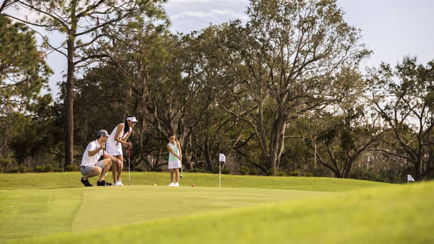 A family playing golf on a golf course