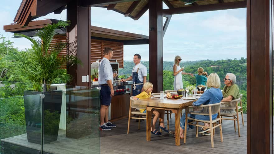 Multi-gen family enjoying a barbecue on the terrace