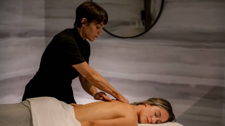 Guest laying on massage table while getting a massage.