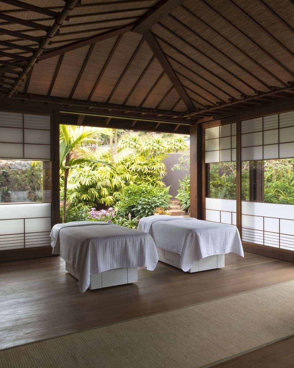 An airy indoor spa surrounded by lush flora
