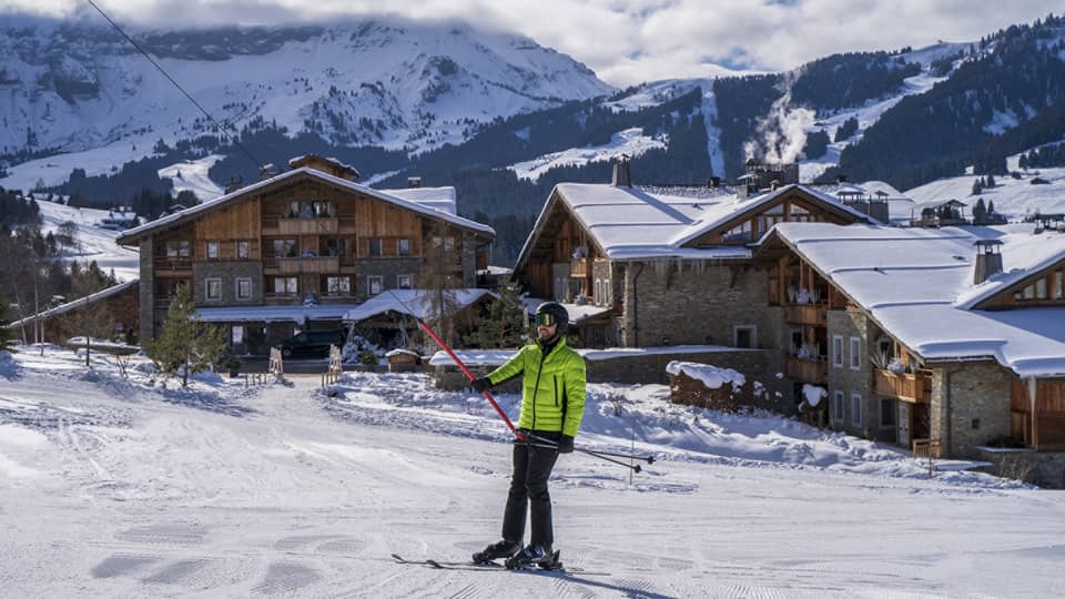 A person in a bright green ski jacket on snow.