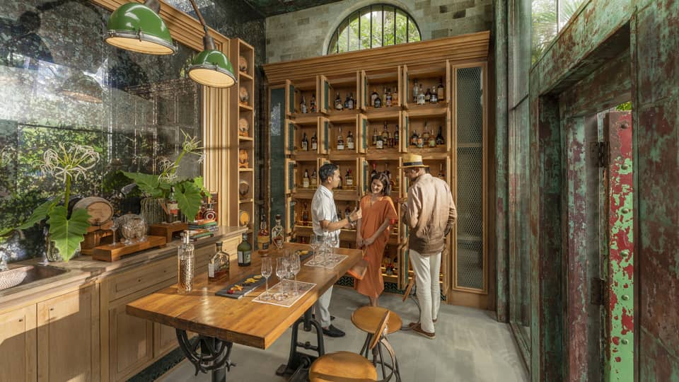Male staff members offers samples to couple at Rum Vault
