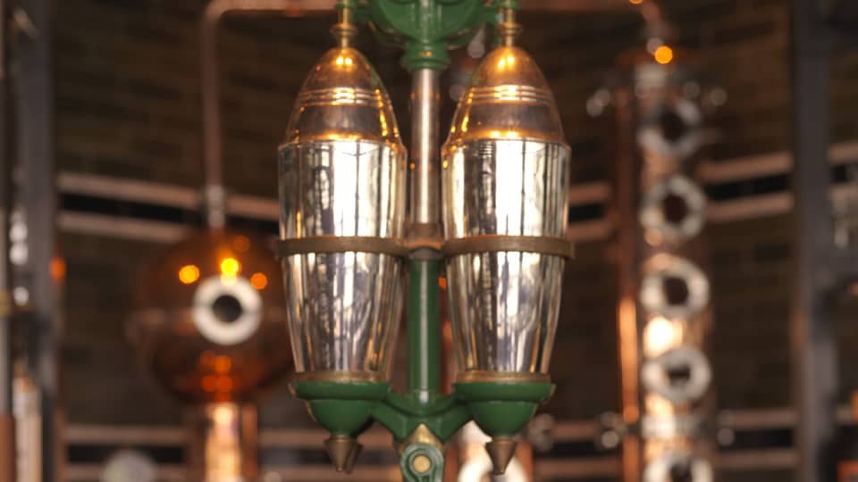 Close-up of copper, silver and green rare 5-foot-tall, hand-operated cocktail shaker at Butcher & Still