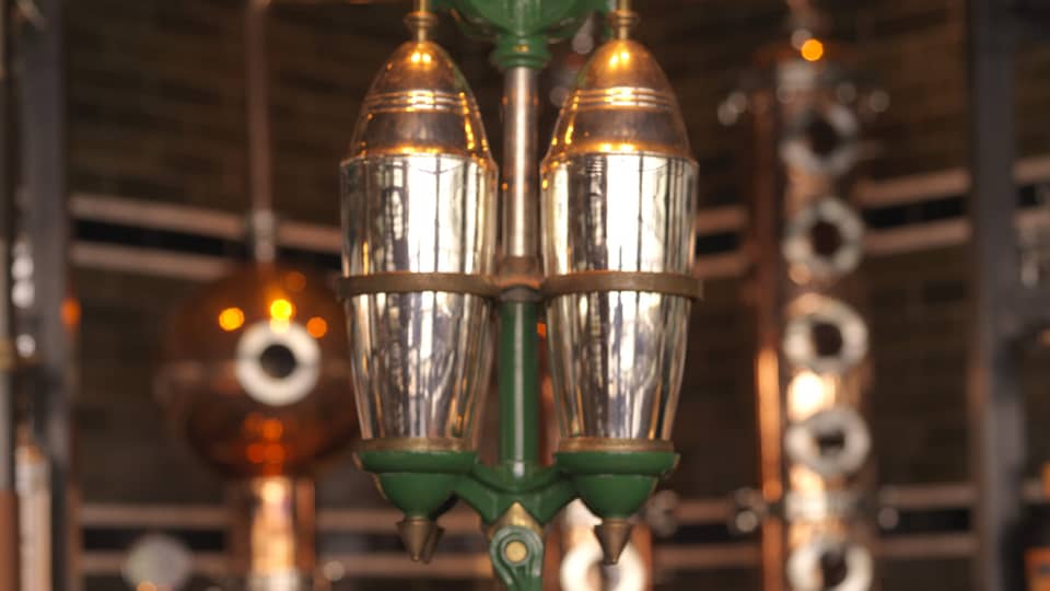 Close-up of copper, silver and green rare 5-foot-tall, hand-operated cocktail shaker at Butcher & Still