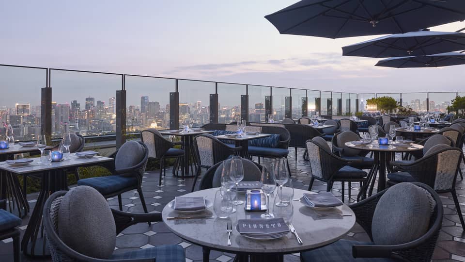 Four Seasons rooftop restaurant with a city skyline views at dusk