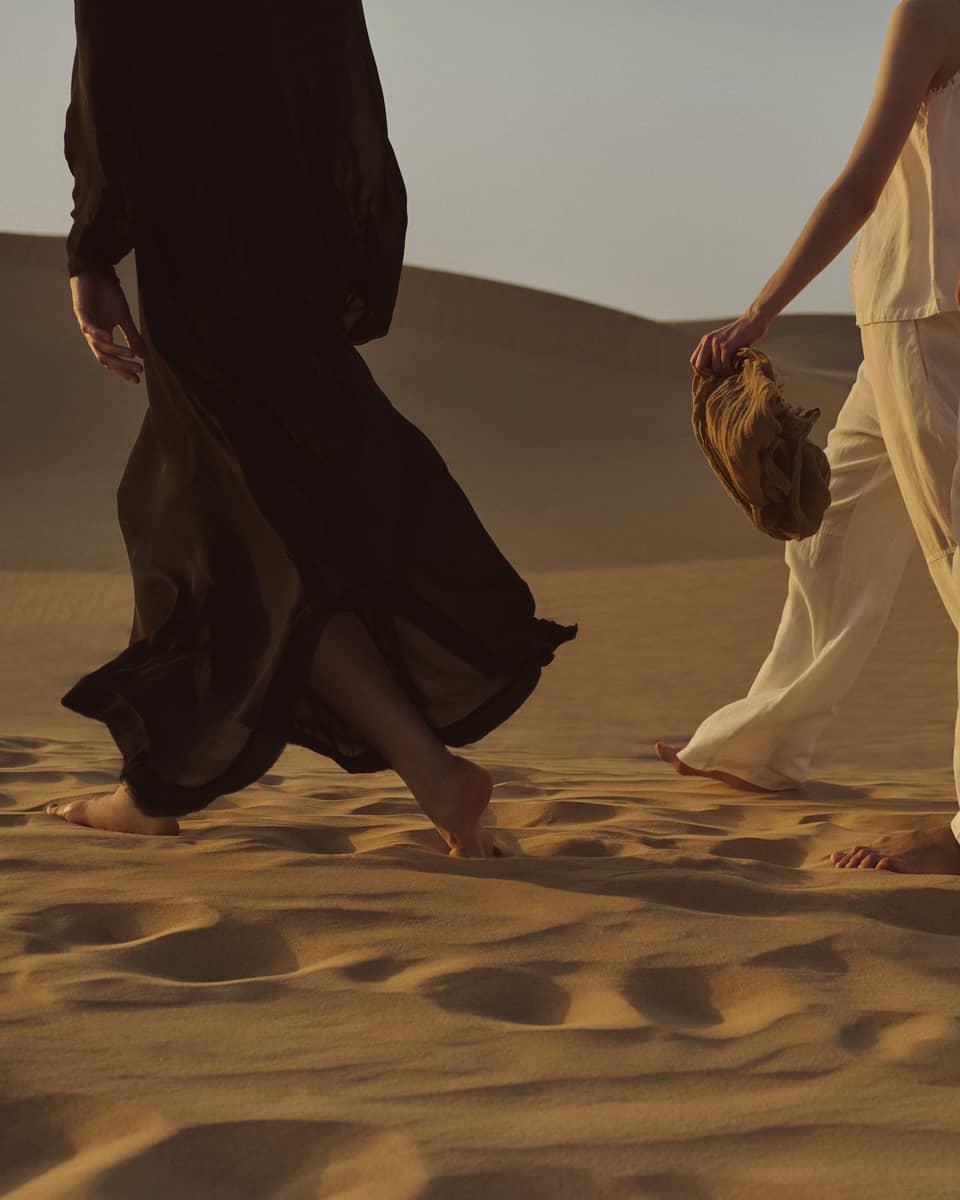 Three people walking in the dessert