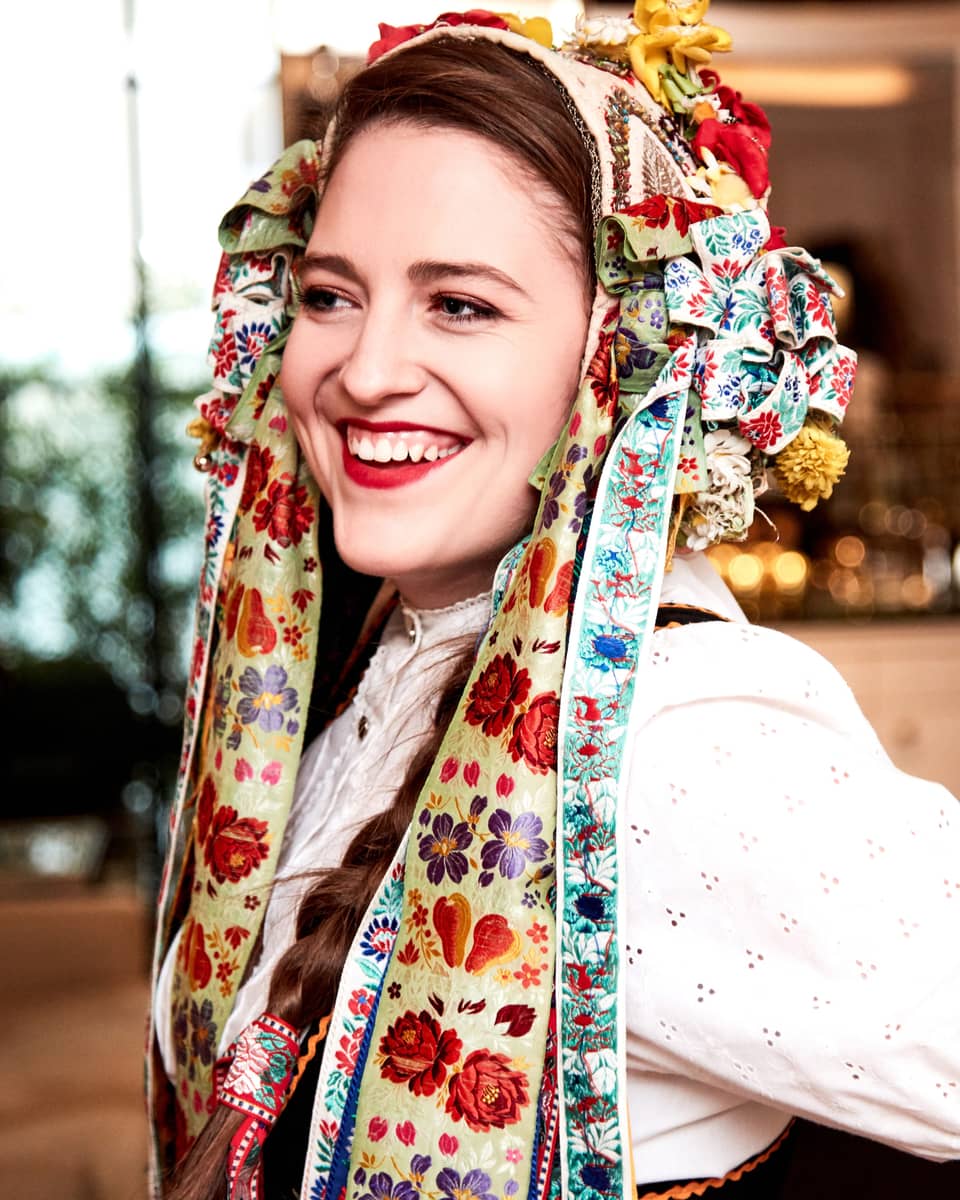 Smiling woman wearing colourful bows and ribbons in hair