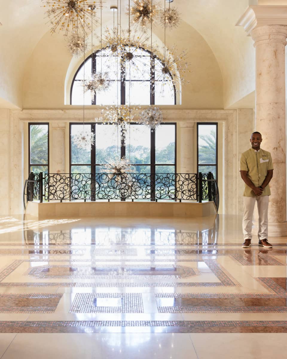 Hotel lobby with flowers and hanging lights.