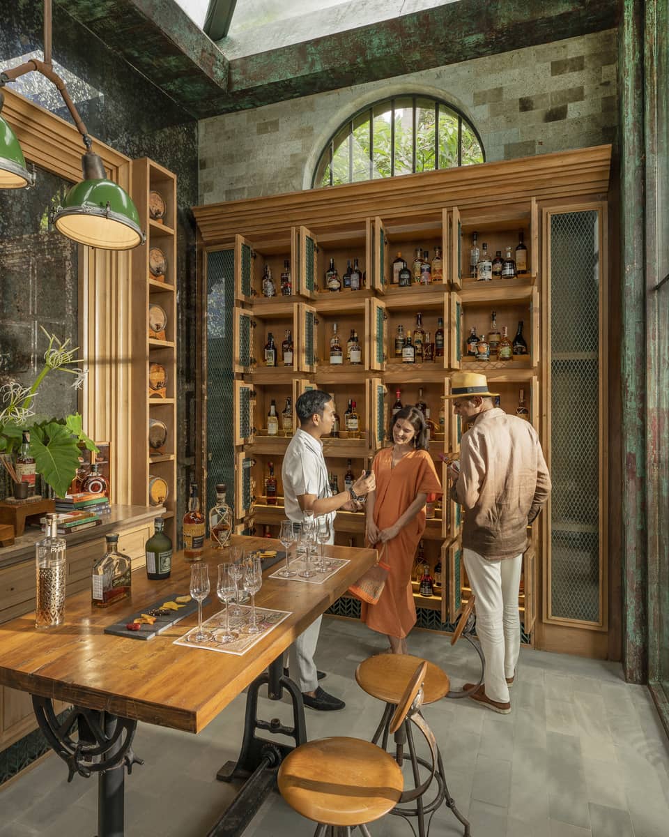 Male staff members offers samples to couple at Rum Vault