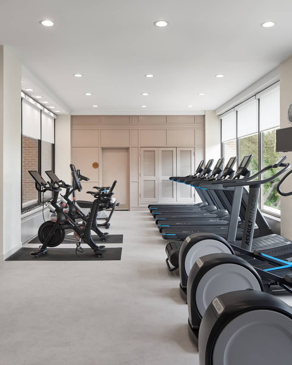 Fitness centre with multiple treadmills, bicycles and ellipticals.