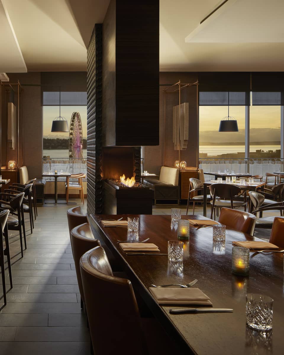 A dimly lit restaurant with large windows.