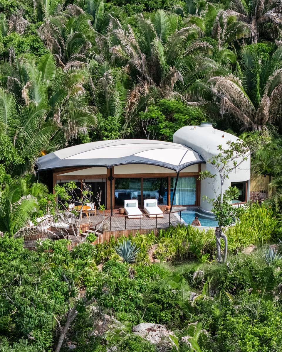 Secluded bungalow set in a lush, green tropical landscape